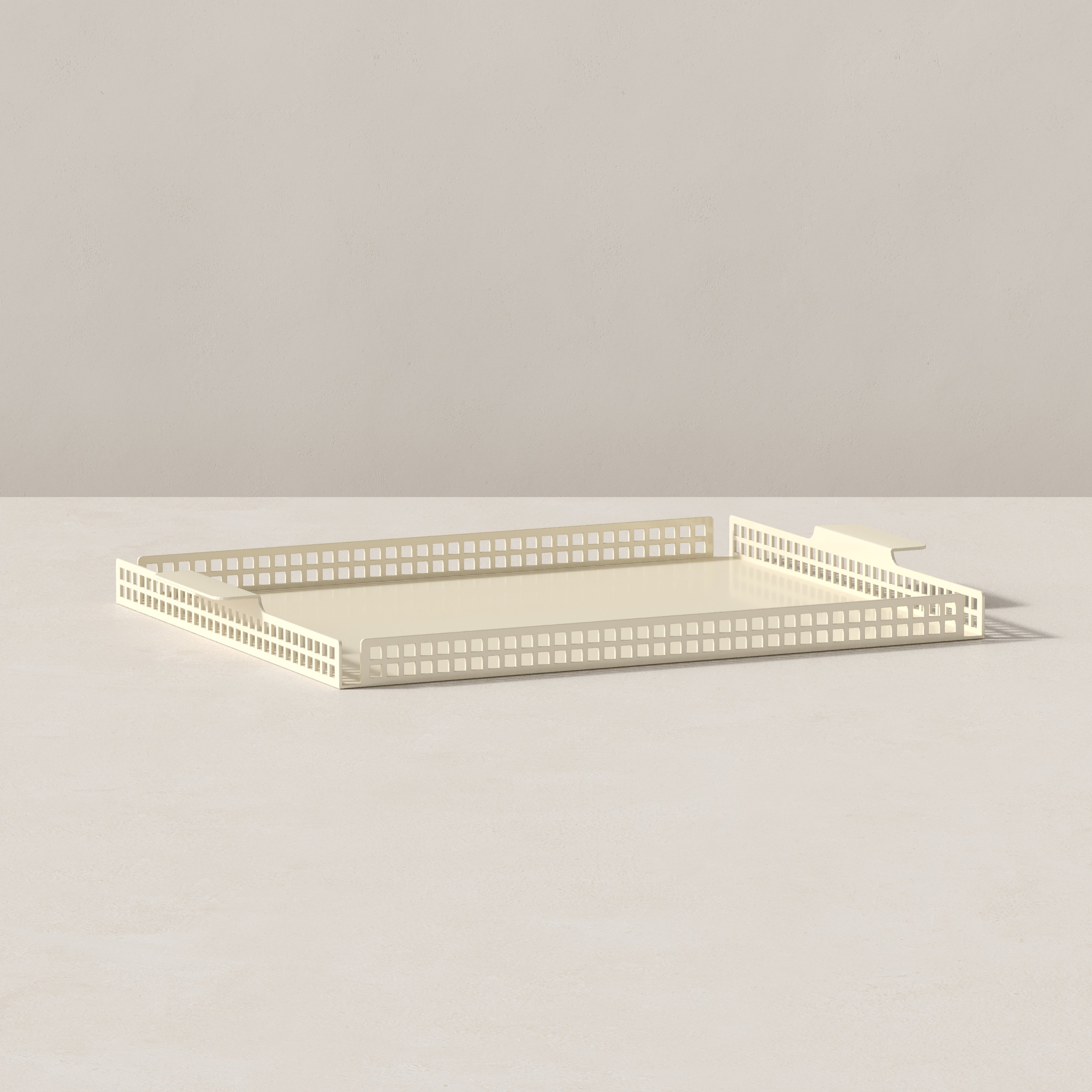 End view of butter cream Art Deco serving tray highlighting geometric perforated detailing