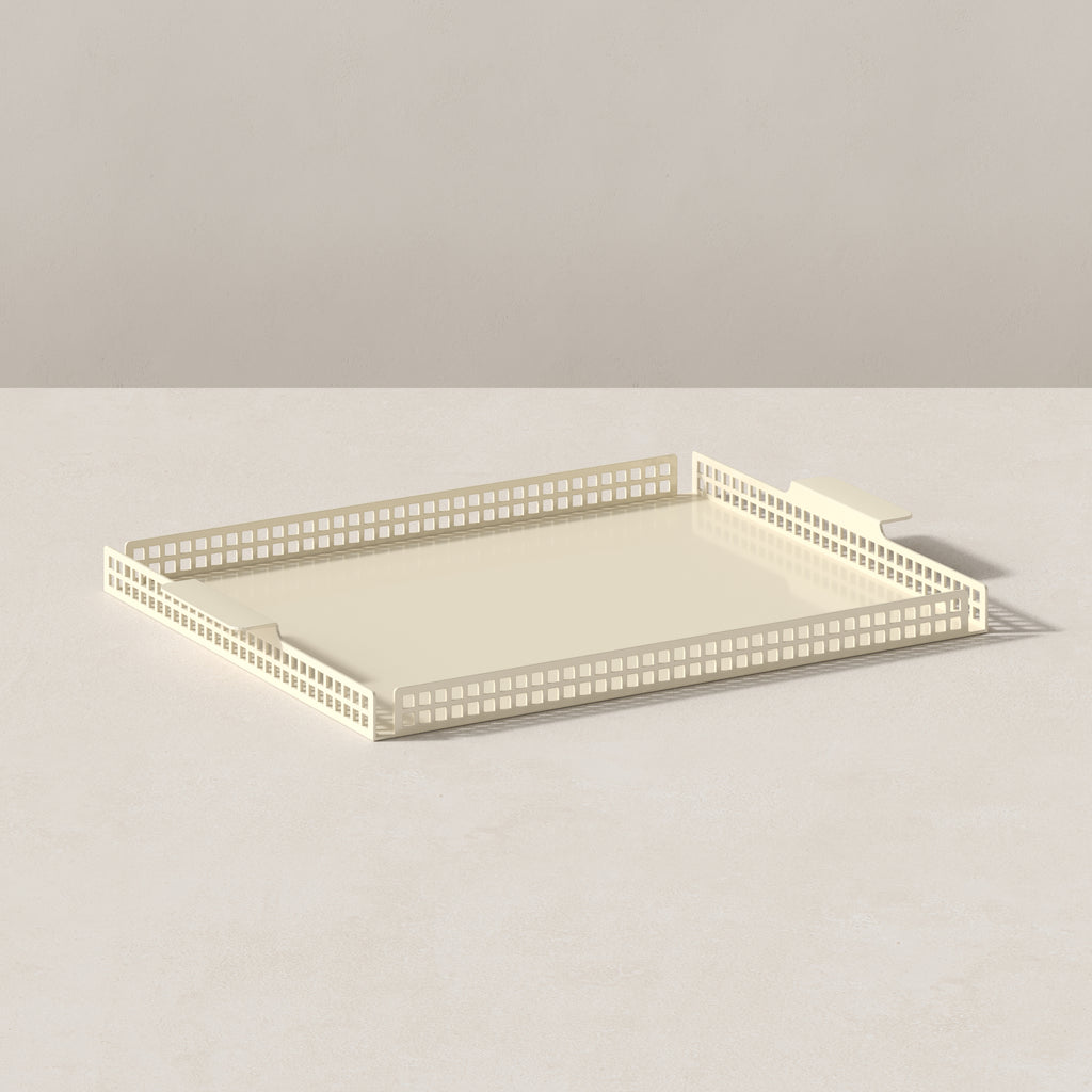 Art Deco serving tray in butter cream finish, angled view showing perforated steel sides