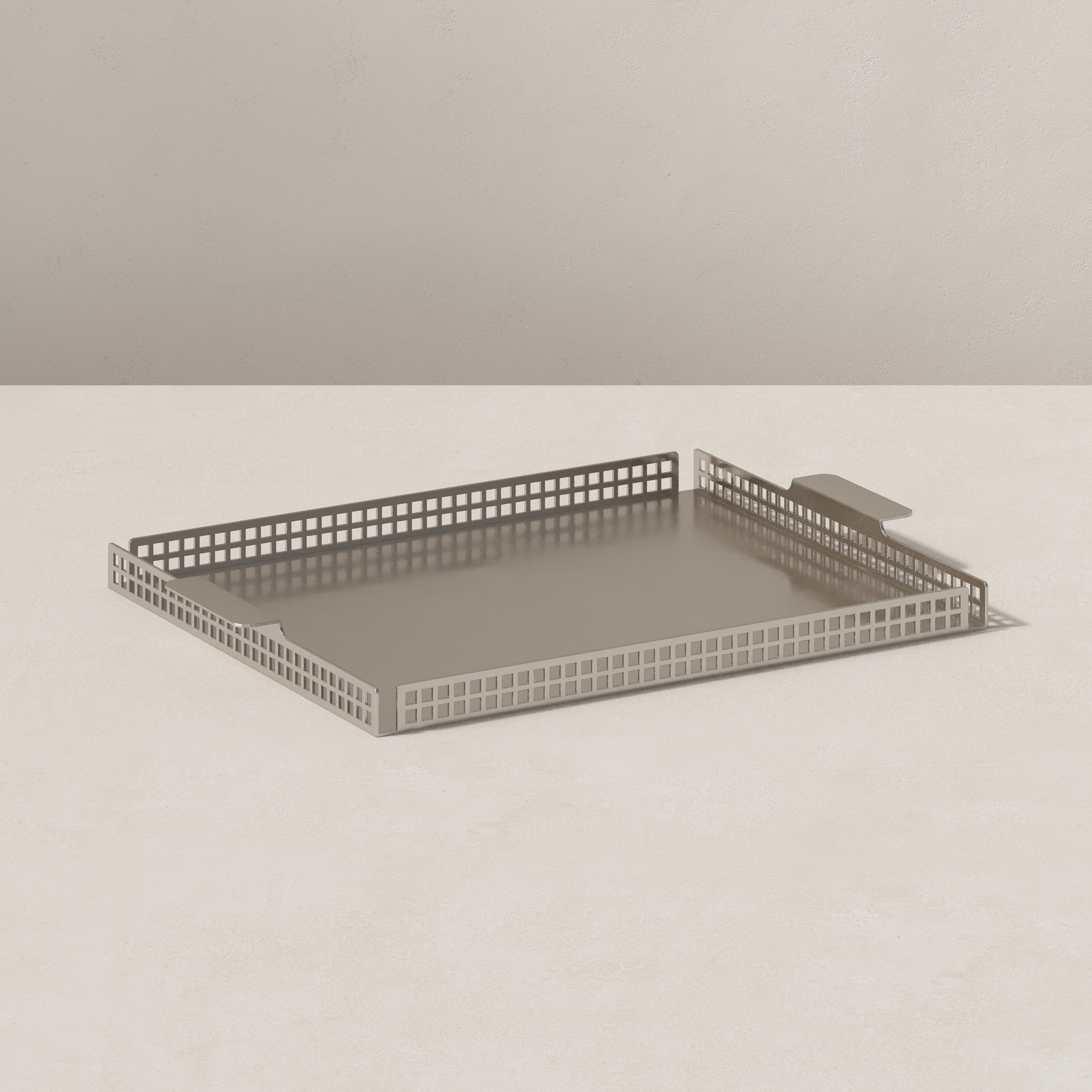 Art Deco nickel serving tray, end view highlighting geometric perforated edge detail