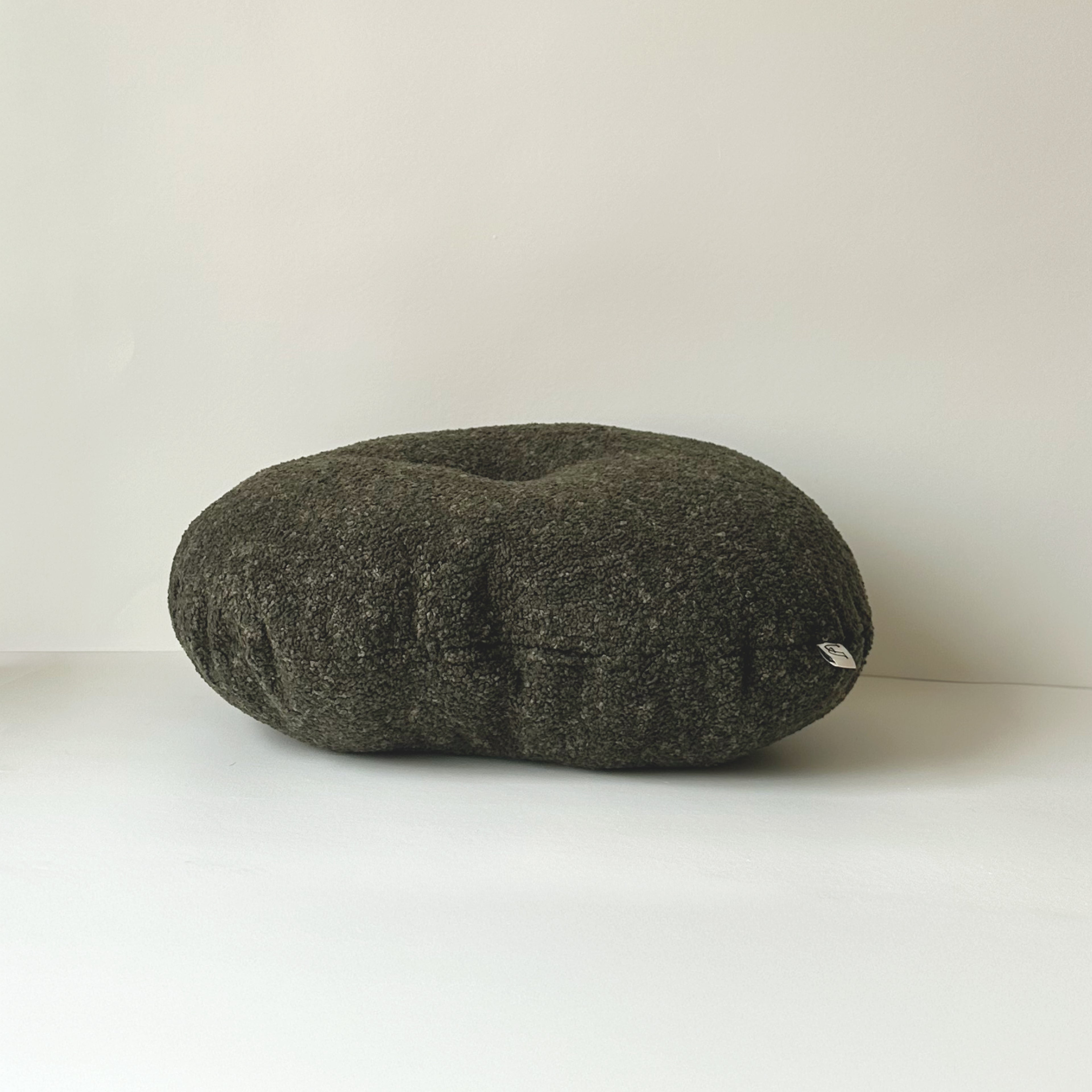 Side view of Cloud Cushion in moss textured bouclé