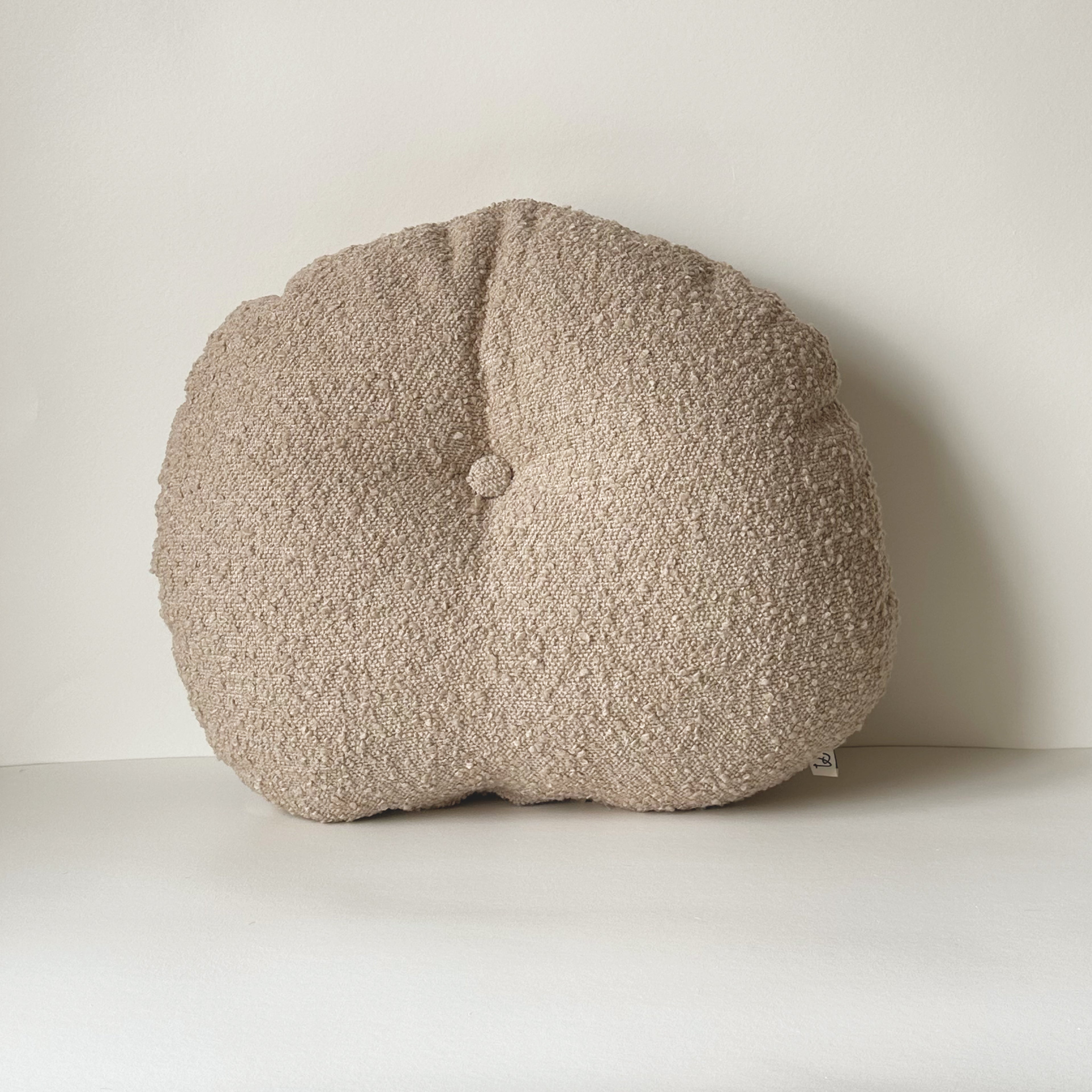 Cloud Cushion in oatmeal bouclé shown from the side